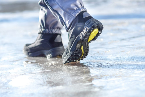 An icy, uneven sidewalk where slip, trip and fall accidents may likely take place.